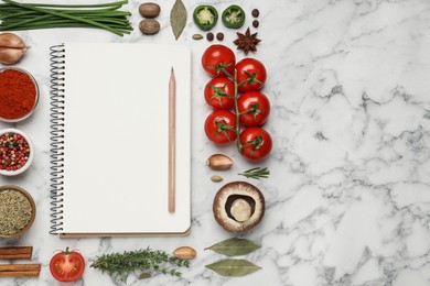 Open recipe book and different ingredients on white marble table, flat lay. Space for text