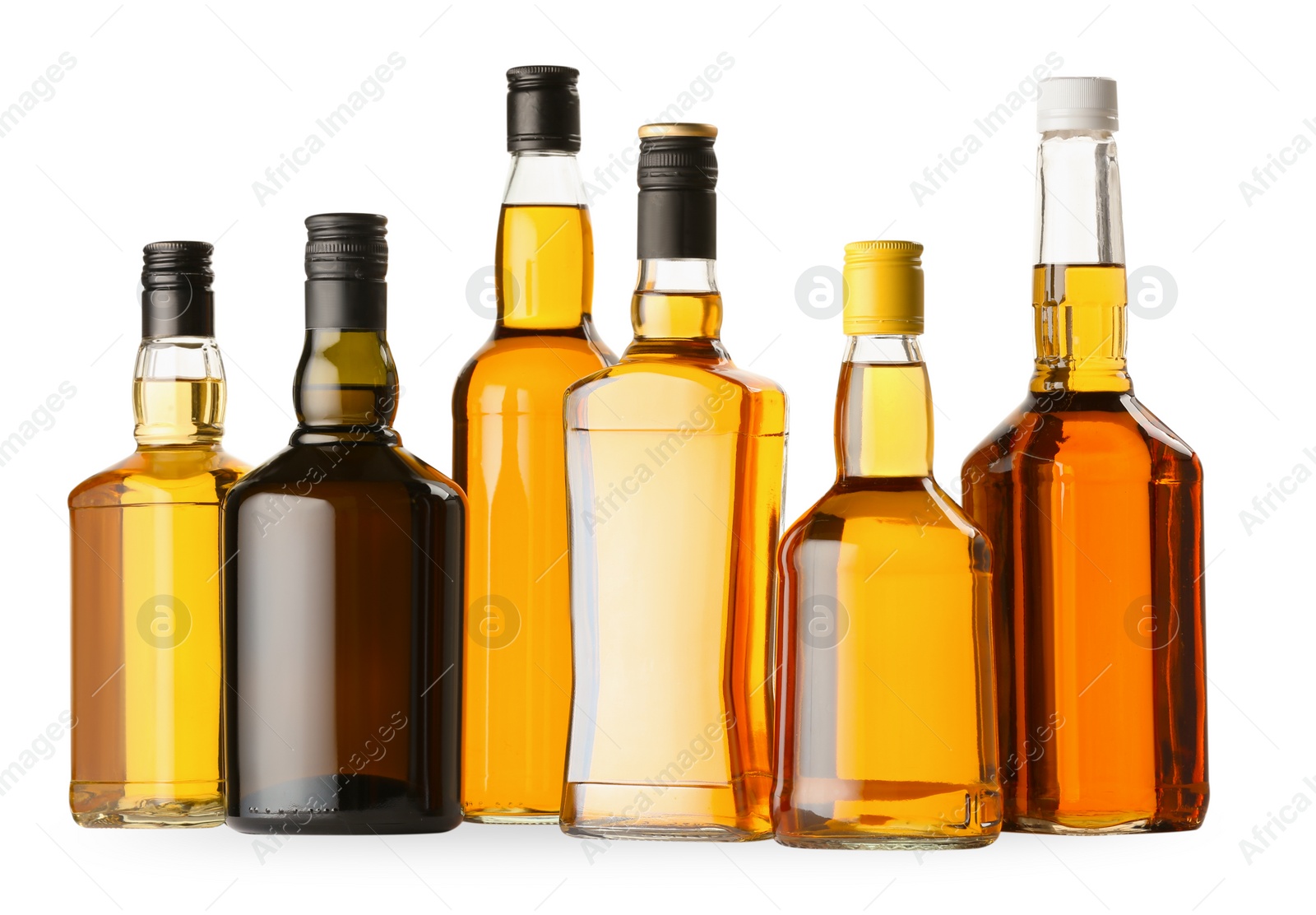 Photo of Different sorts of whiskey in glass bottles isolated on white