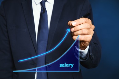 Image of Salary increase concept. Man drawing up arrow on virtual screen, closeup