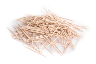 Heap of wooden toothpicks on white background