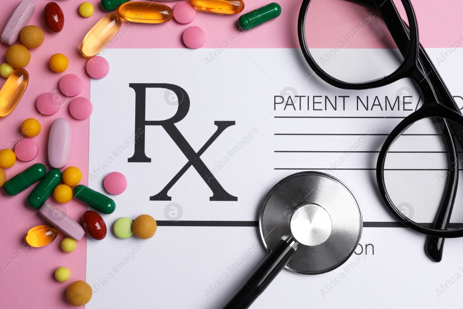 Photo of Medical prescription form, pills, glasses and stethoscope on pink background, flat lay