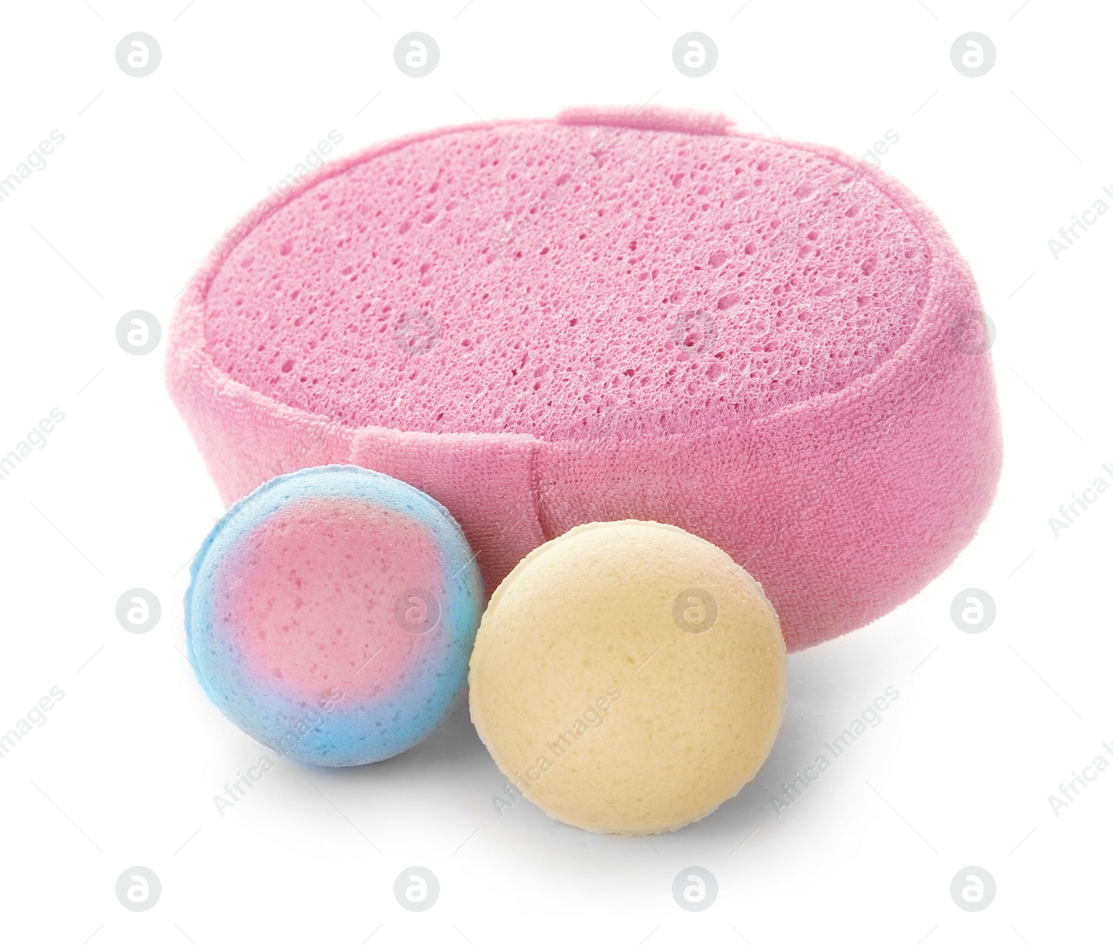 Photo of Pink sponge and bath bombs on white background