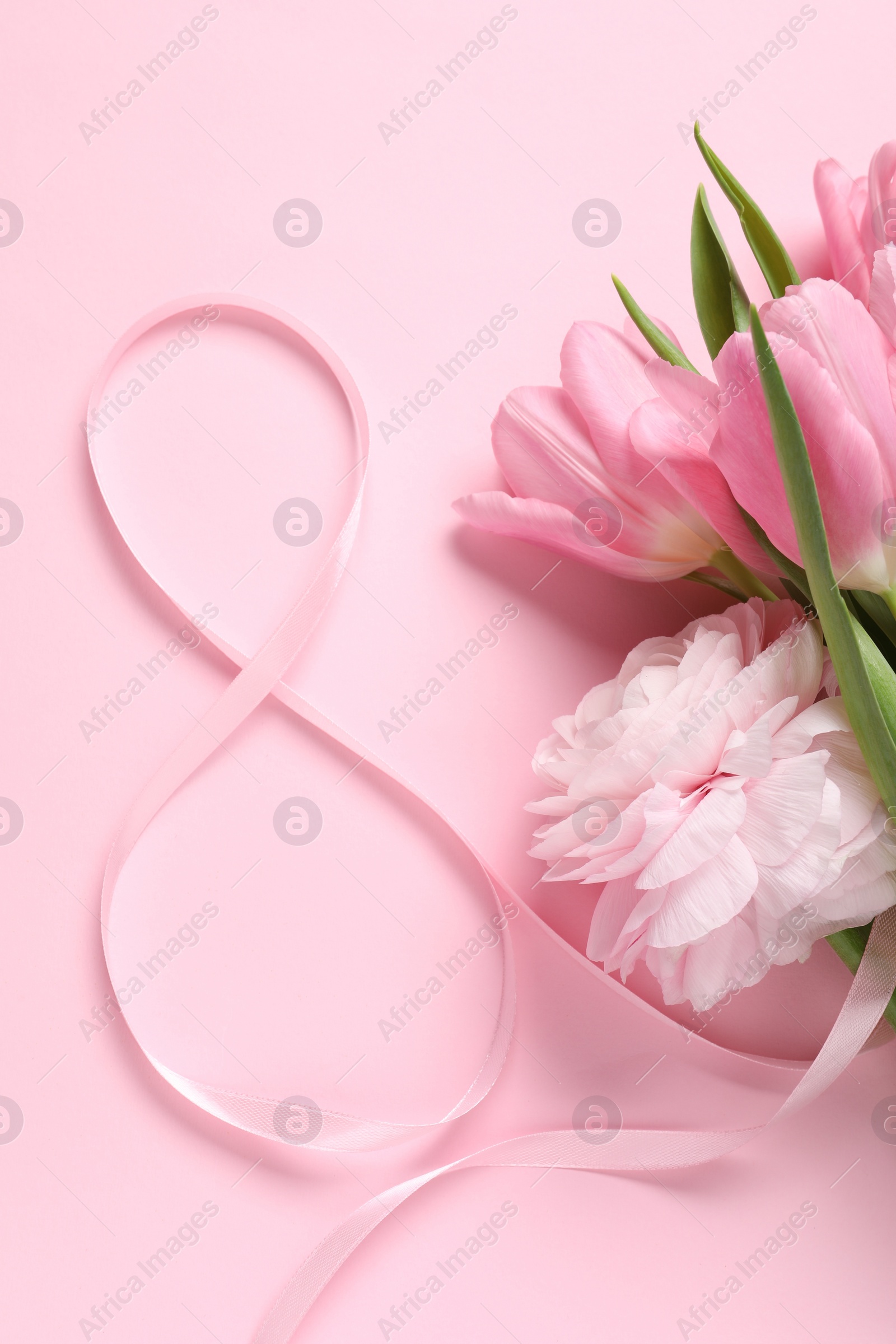 Photo of 8th of March greeting card design with ribbon and beautiful flowers on pink background, flat lay. International Women's day