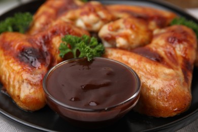 Photo of Fresh marinade and chicken wings on table, closeup