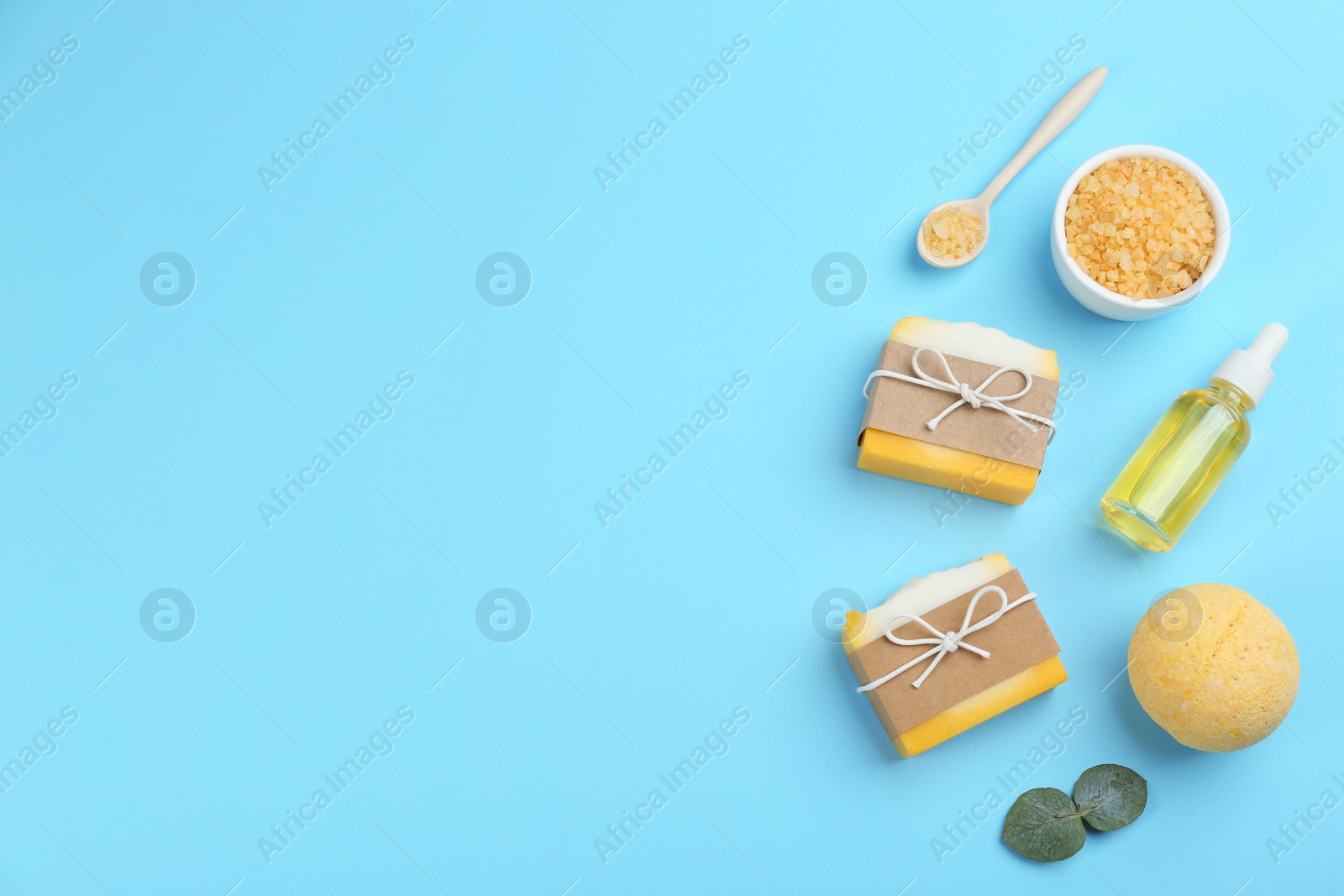 Photo of Flat lay composition with natural handmade soap on light blue background. Space for text