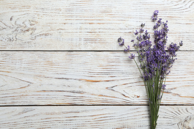 Beautiful fresh lavender flowers on white wooden background, top view. Space for text