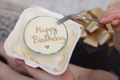 Woman eating her Birthday cake indoors, closeup