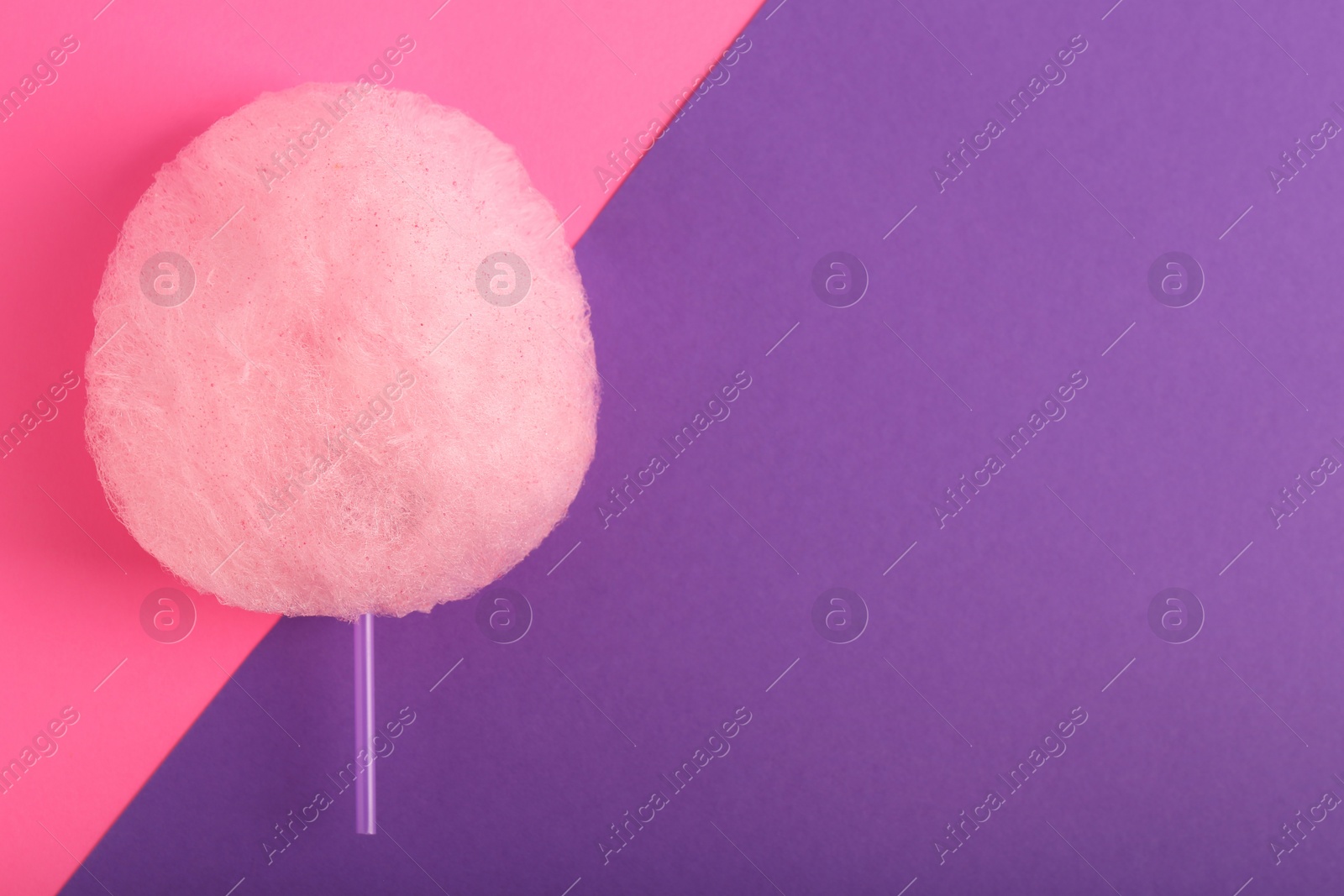 Photo of One sweet cotton candy on color background, top view. Space for text