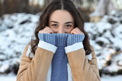Portrait of young woman in snowy park