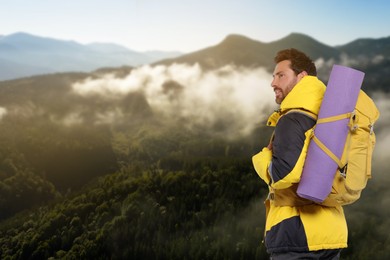 Happy tourist with yellow backpack in mountains