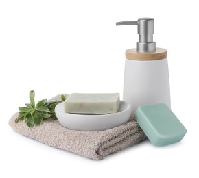 Soap bars, dispenser and terry towel on white background