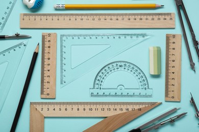 Flat lay composition with different rulers and protractor on turquoise background