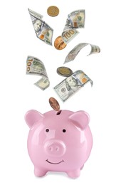 Image of Banknotes and coins falling into piggy bank on white background. Saving money