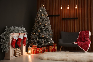 Photo of Stylish Christmas interior with decorated fir tree and fireplace