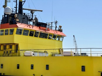 Ship moored in sea port on sunny day