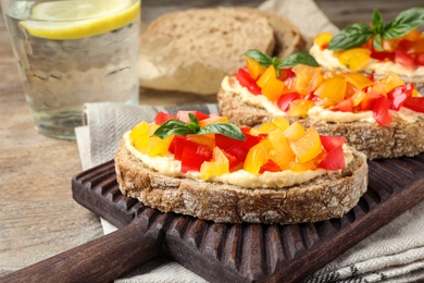 Tasty fresh tomato bruschettas on wooden board