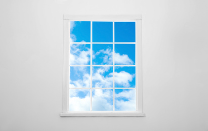 Image of Beautiful view on blue sky with clouds through window