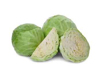 Whole and cut fresh ripe cabbages on white background