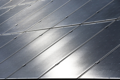Photo of Solar panels installed outdoors, closeup. Alternative energy source