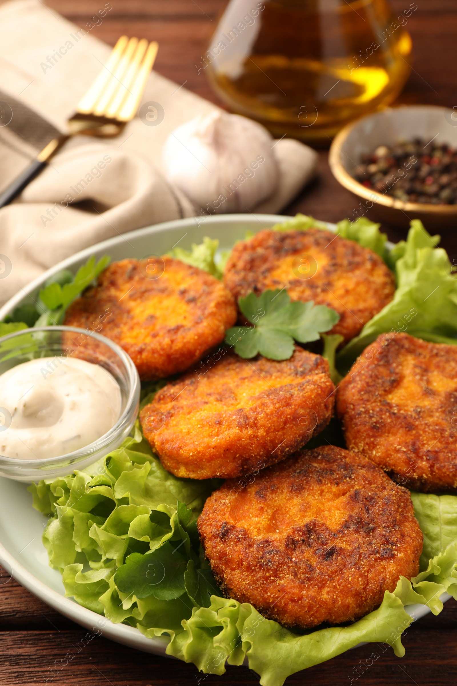 Photo of Tasty vegan cutlets with sauce on table, closeup