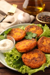 Photo of Tasty vegan cutlets with sauce on table, closeup