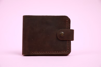 Photo of Stylish brown leather wallet on pink background