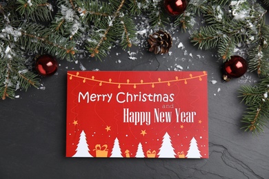 Photo of Flat lay composition with greeting card and Christmas decor on black background