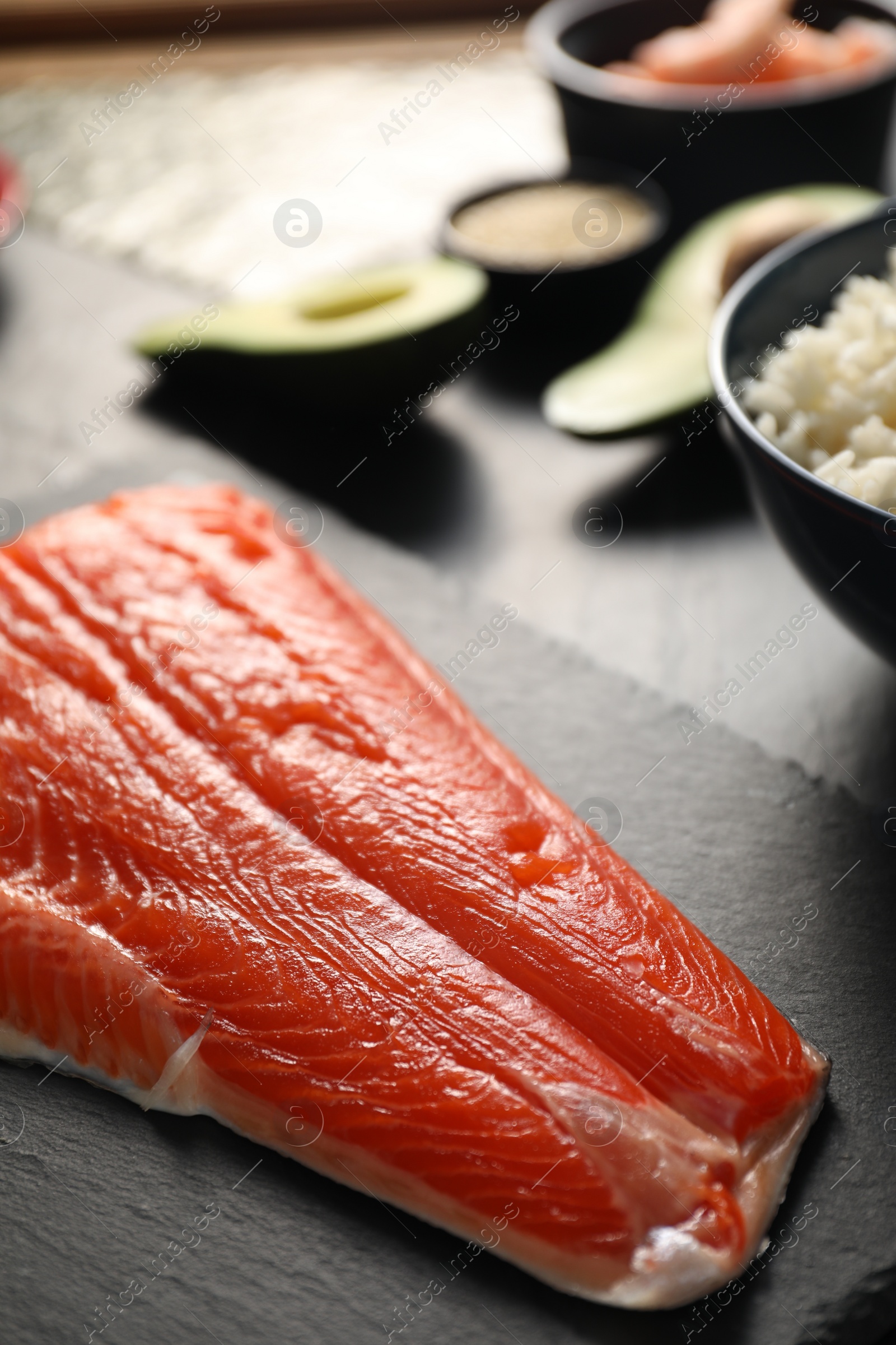 Photo of Fresh salmon for sushi on dark table, closeup