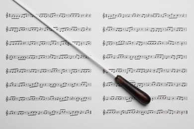 Conductor's baton on sheet music, top view
