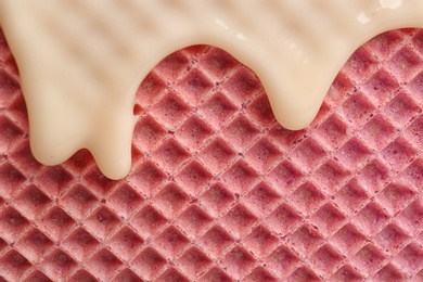 Photo of Hot white chocolate on wafer, closeup. Crispy food