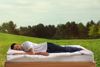 Man sleeping on bed and beautiful view of green lawn on background. Sleep well - stay healthy