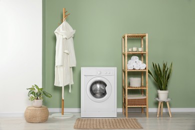 Stylish laundry room with washing machine. Interior design