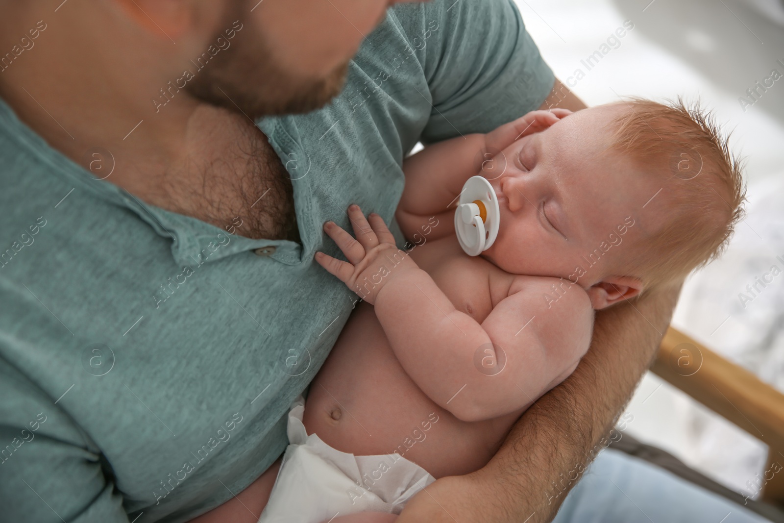 Photo of Father with his newborn son, closeup view