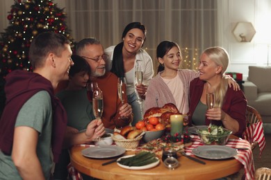 Photo of Happy family enjoying festive dinner at home. Christmas celebration