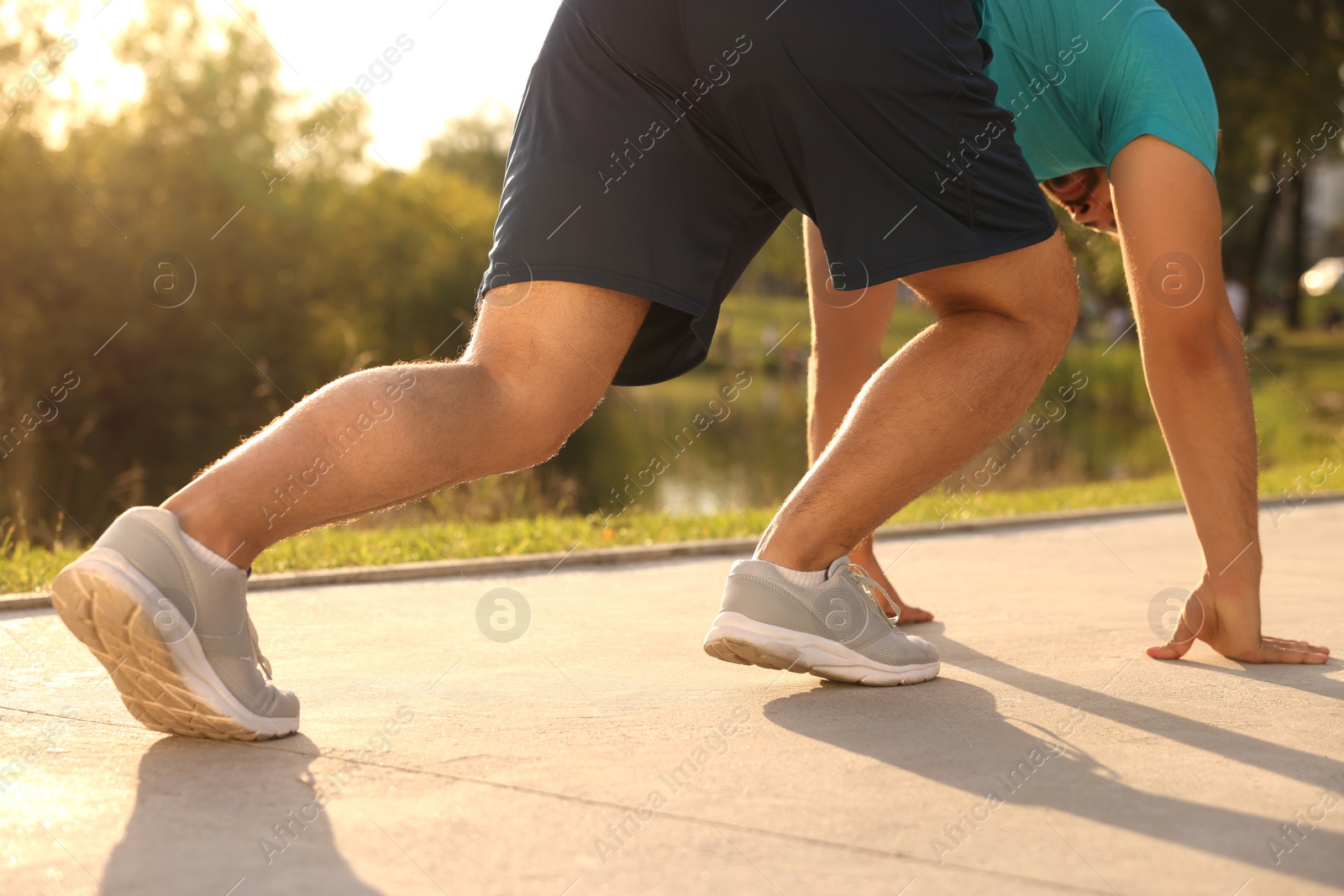 Photo of Runner on starting position in park on sunny day, closeup