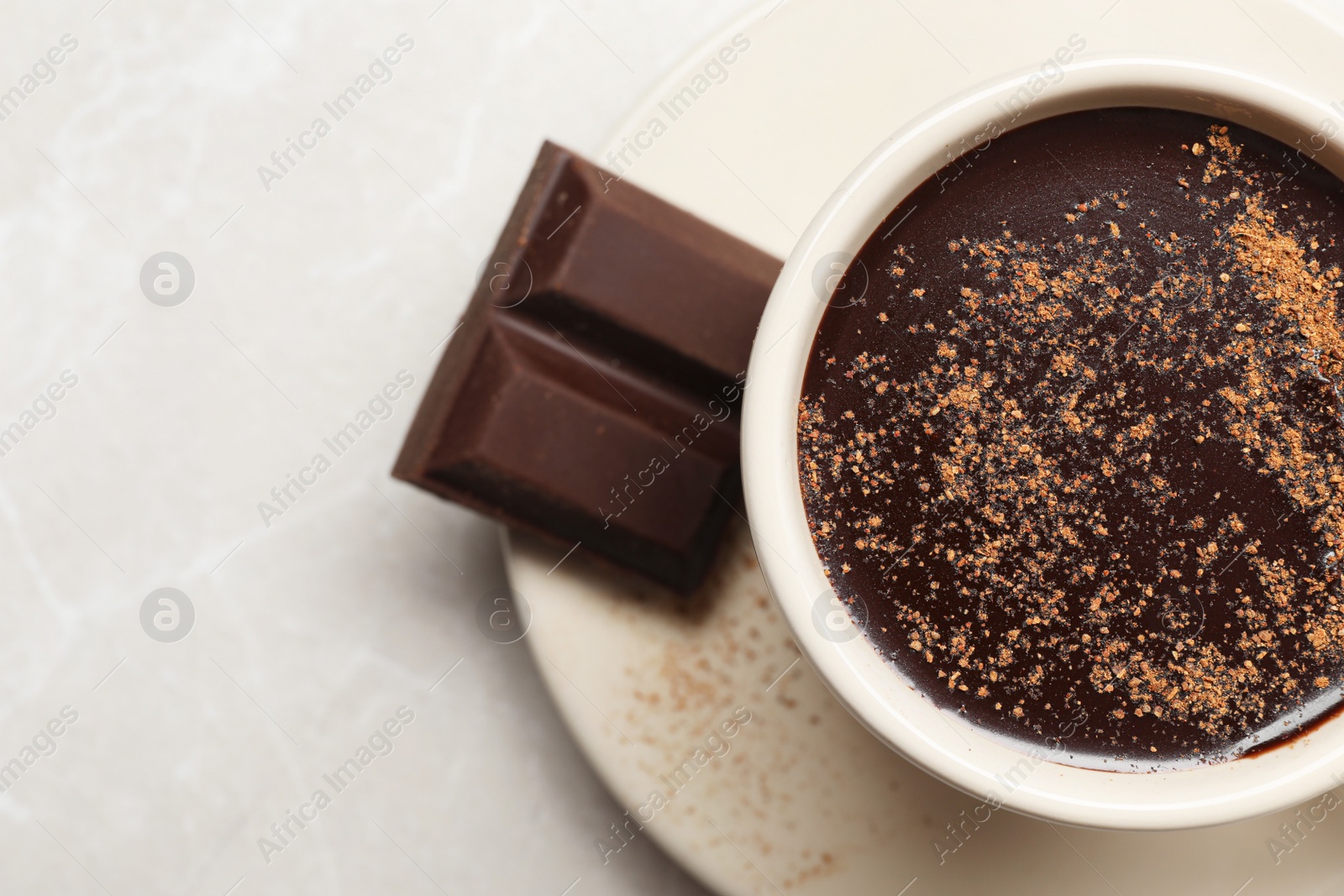 Photo of Cup of delicious hot chocolate on grey table, top view. Space for text