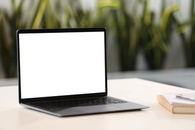 Modern laptop on desk in office. Mockup for design