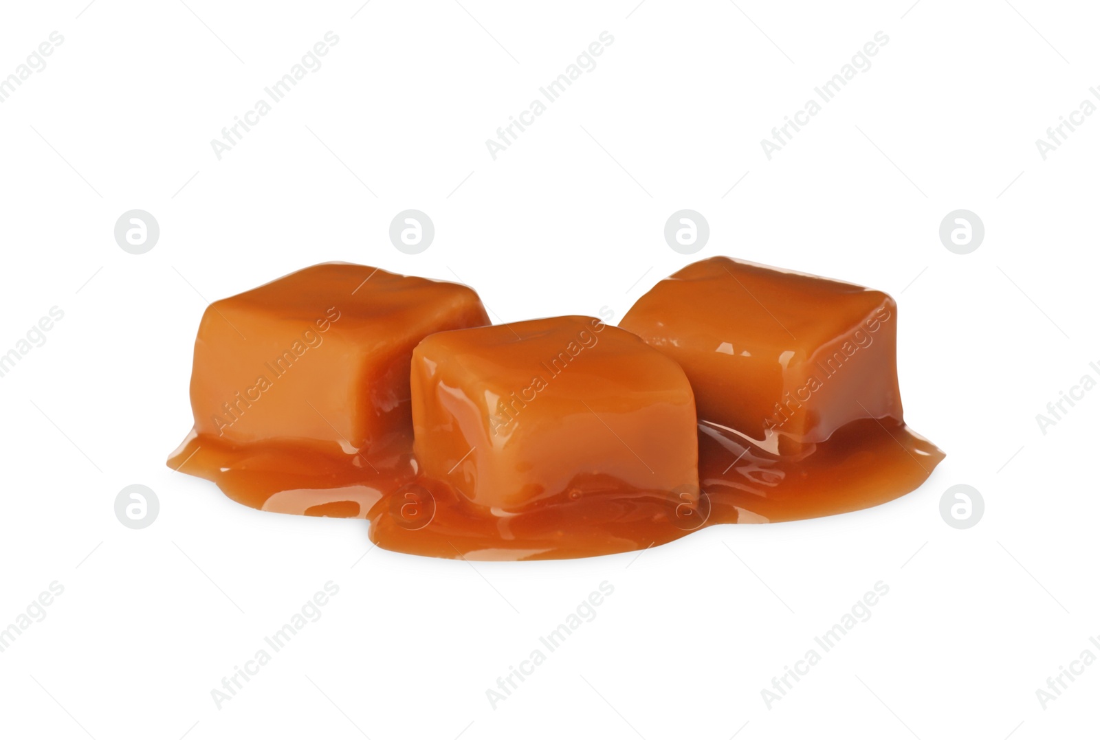 Photo of Caramel candies with topping on white background