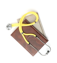 Photo of Student textbooks and stethoscope on white background, top view. Medical education