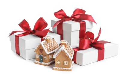 Photo of Christmas present. Gift boxes and small gingerbread houses on white background