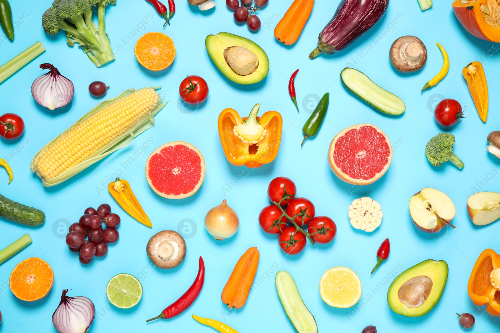 Photo of Flat lay composition with fresh organic fruits and vegetables on light blue background