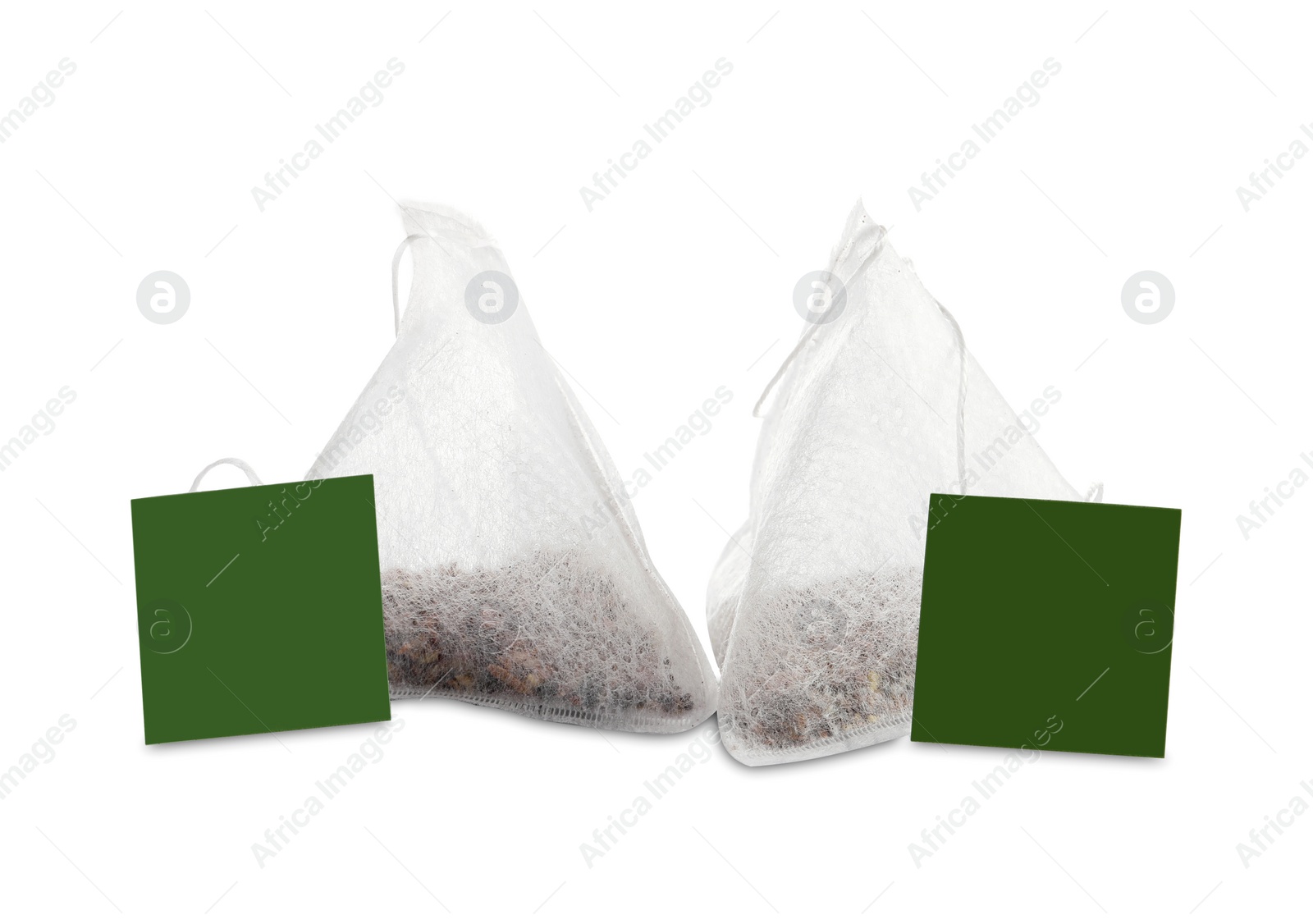 Photo of New pyramid tea bags on white background