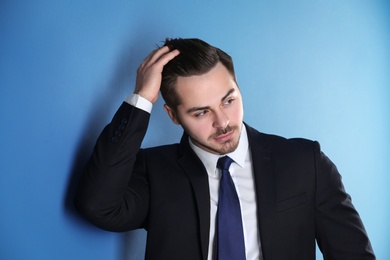 Photo of Portrait of young man with beautiful hair on color background