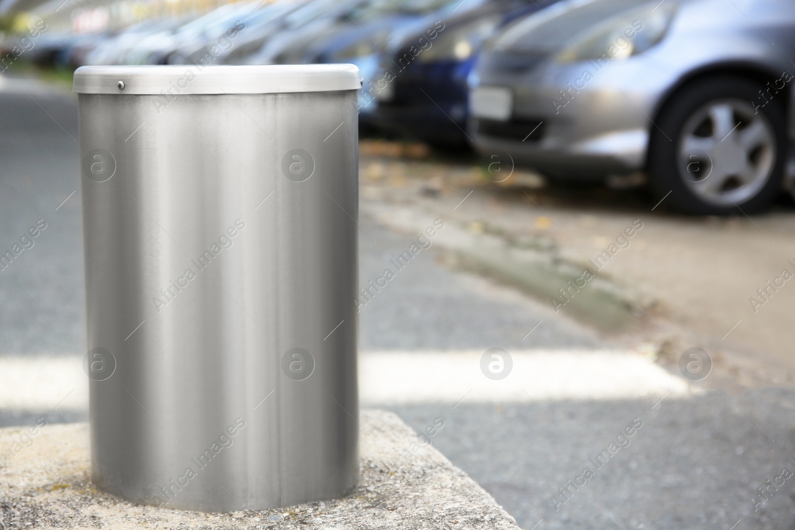 Photo of Bollard near parking on autumn day outdoors, space for text