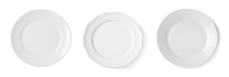 Set of different ceramic plates on white background, top view