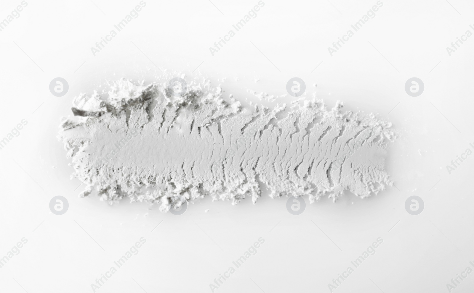 Photo of Crushed eye shadow on white background. Professional makeup products