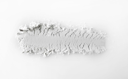 Photo of Crushed eye shadow on white background. Professional makeup products