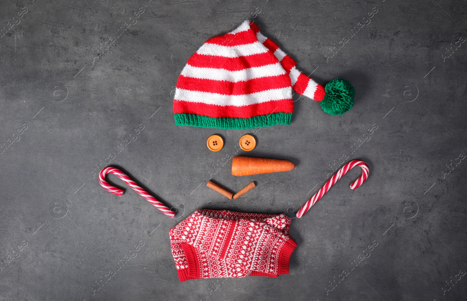 Photo of Funny snowman made with different elements on grey background, flat lay