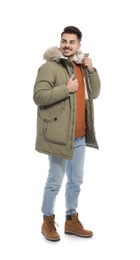 Young man wearing warm clothes on white background. Ready for winter vacation