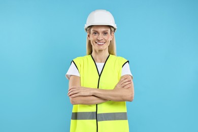 Photo of Engineer in hard hat on light blue background